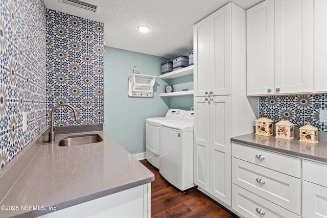 182 N Ridge Dr, Fleming Island, FL 32003 - washroom with washing machine and clothes dryer, cabinet space, dark wood-style floors, and a textured ceiling