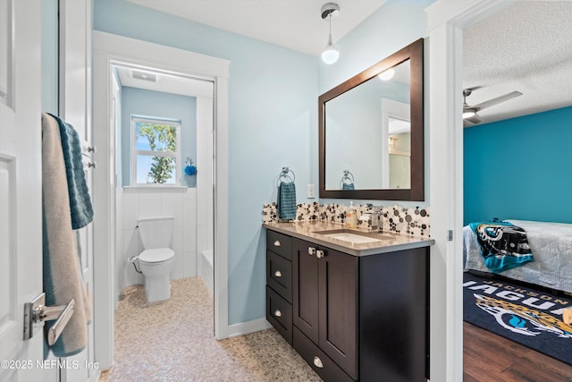182 N Ridge Dr, Fleming Island, FL 32003 - full bathroom with connected bathroom, vanity, toilet, and a textured ceiling