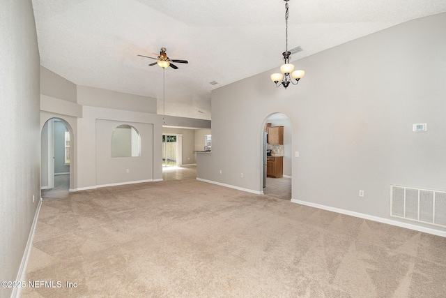 133 Sterling Hill Dr, Jacksonville, FL 32225 - unfurnished living room featuring arched walkways, a ceiling fan, baseboards, light carpet, and a chandelier