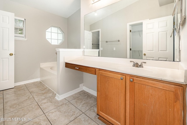 133 Sterling Hill Dr, Jacksonville, FL 32225 - full bathroom with lofted ceiling, vanity, a garden tub, baseboards, and tile patterned flooring