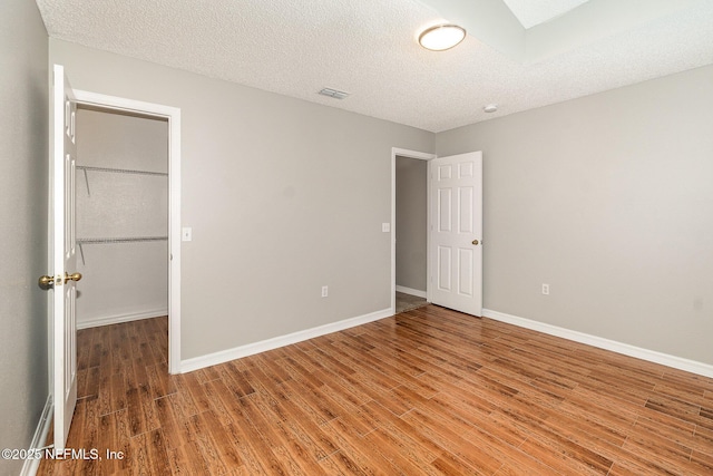 133 Sterling Hill Dr, Jacksonville, FL 32225 - unfurnished bedroom with wood finished floors, baseboards, and a textured ceiling