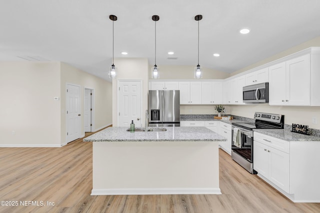1902 Gillis St, Palatka, FL 32177 - kitchen featuring stainless steel appliances, a sink, light wood-type flooring, a center island with sink, and recessed lighting