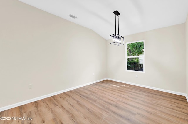 1902 Gillis St, Palatka, FL 32177 - unfurnished dining area featuring a chandelier, baseboards, light wood finished floors, and lofted ceiling