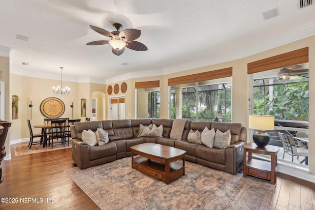 1700 Eagle Watch Dr, Fleming Island, FL 32003 - living area with ceiling fan, hardwood / wood-style floors, ornamental molding, a chandelier, and a textured ceiling