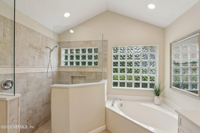 1700 Eagle Watch Dr, Fleming Island, FL 32003 - bathroom featuring walk in shower, healthy amount of natural light, a garden tub, lofted ceiling, and recessed lighting