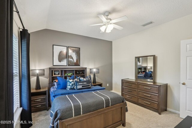 1700 Eagle Watch Dr, Fleming Island, FL 32003 - bedroom featuring light colored carpet, lofted ceiling, baseboards, ceiling fan, and a textured ceiling