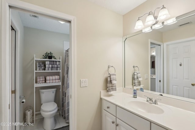 1700 Eagle Watch Dr, Fleming Island, FL 32003 - bathroom with toilet, vanity, and tile patterned flooring