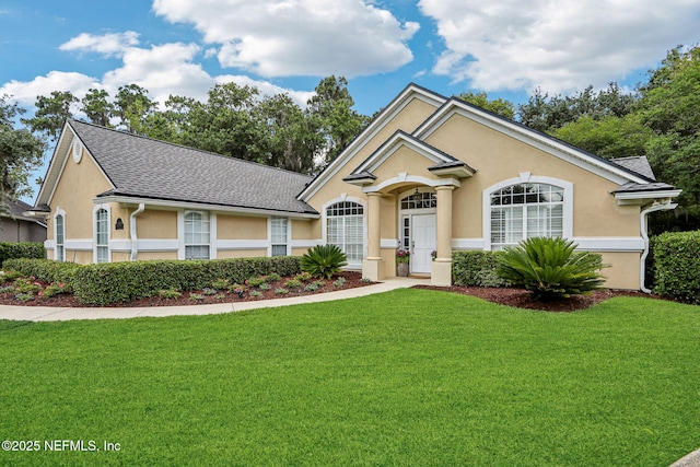 1700 Eagle Watch Dr, Fleming Island, FL 32003 - ranch-style home with a front lawn, stucco siding, and roof with shingles