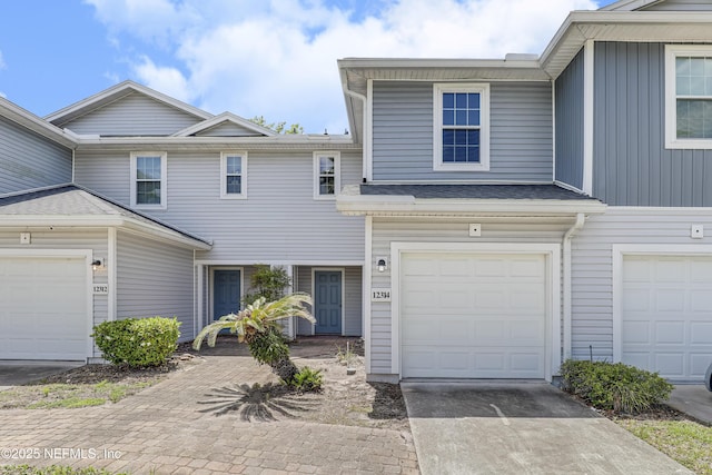 12314 Mangrove Forest Ct, Jacksonville, FL 32218 - townhome / multi-family property with concrete driveway and an attached garage