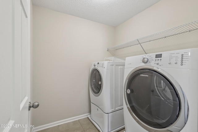 168 Nelson Ln, Saint Johns, FL 32259 - clothes washing area with independent washer and dryer, light tile patterned floors, baseboards, and a textured ceiling
