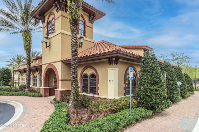 168 Nelson Ln, Saint Johns, FL 32259 - view of side of property with stucco siding, a tile roof, and fence