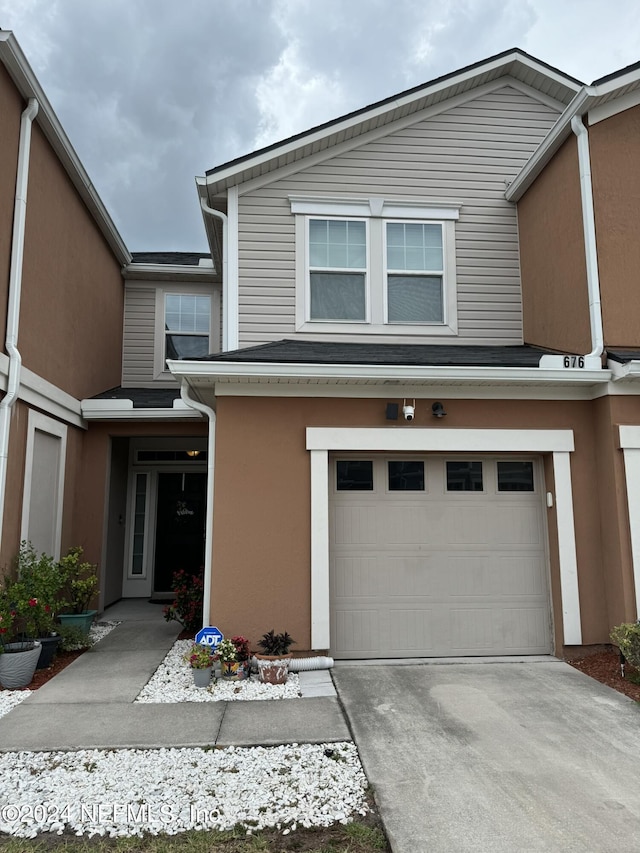 676 Reese Ave, Orange Park, FL 32065 - view of front of house featuring an attached garage, stucco siding, and concrete driveway