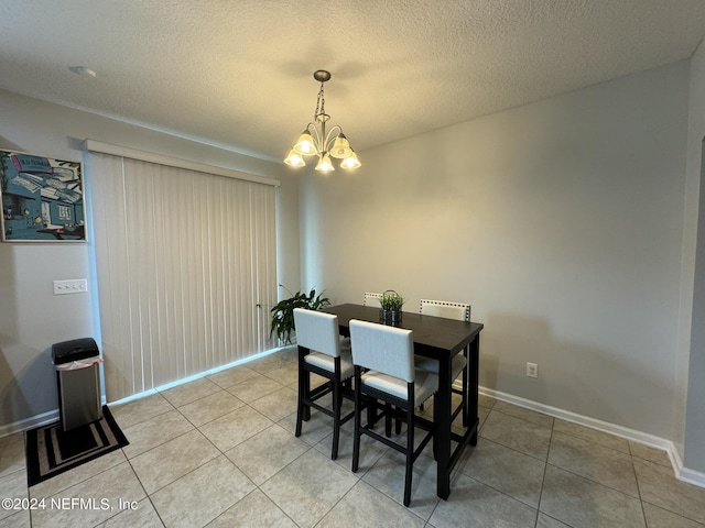 676 Reese Ave, Orange Park, FL 32065 - dining area featuring a chandelier, light tile patterned flooring, a textured ceiling, and baseboards