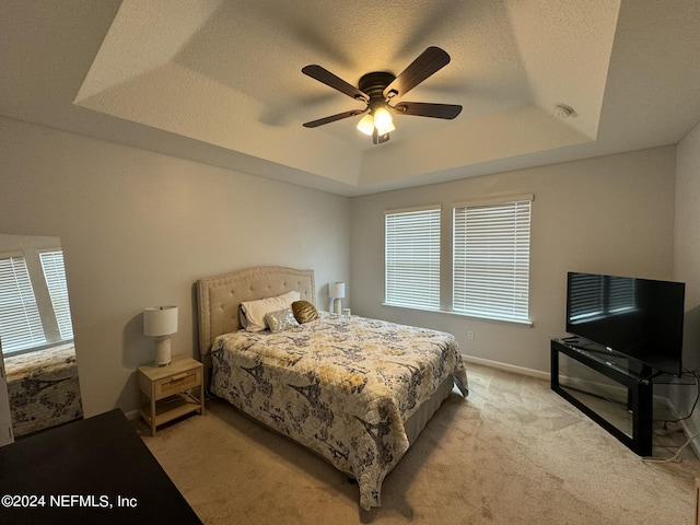 676 Reese Ave, Orange Park, FL 32065 - bedroom featuring a tray ceiling, light colored carpet, ceiling fan, and baseboards