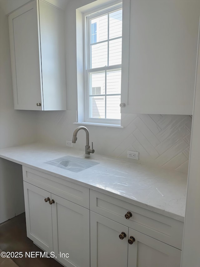 99 Sullivan Pl, Saint Johns, FL 32259 - kitchen featuring white cabinets and light stone counters