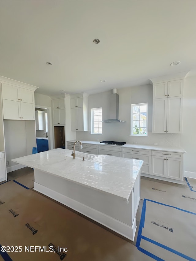 99 Sullivan Pl, Saint Johns, FL 32259 - kitchen featuring wall chimney exhaust hood, stainless steel gas cooktop, white cabinetry, and recessed lighting