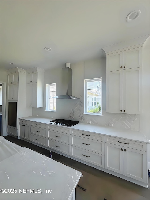 99 Sullivan Pl, Saint Johns, FL 32259 - kitchen featuring island exhaust hood, stovetop, backsplash, and white cabinets