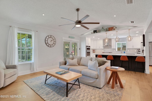 1257 12th St N, Jacksonville Beach, FL 32250 - living area featuring a textured ceiling, light wood-style flooring, ceiling fan, lofted ceiling, and recessed lighting
