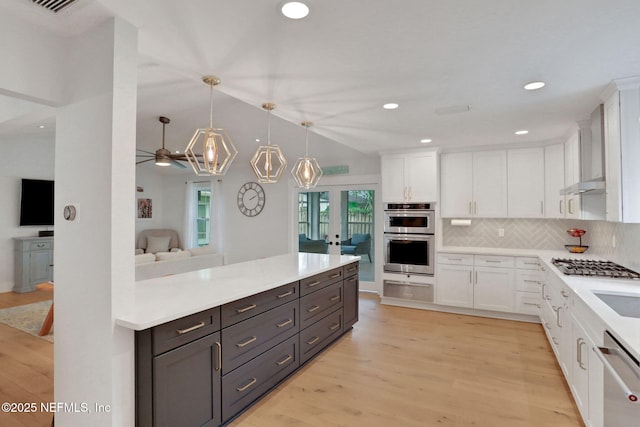 1257 12th St N, Jacksonville Beach, FL 32250 - kitchen featuring stainless steel appliances, white cabinets, a warming drawer, wall chimney exhaust hood, and recessed lighting