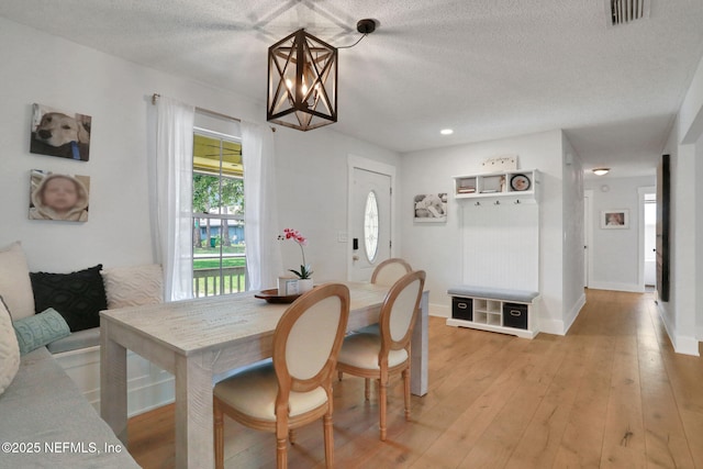 1257 12th St N, Jacksonville Beach, FL 32250 - dining room with light wood-style floors, a textured ceiling, and baseboards