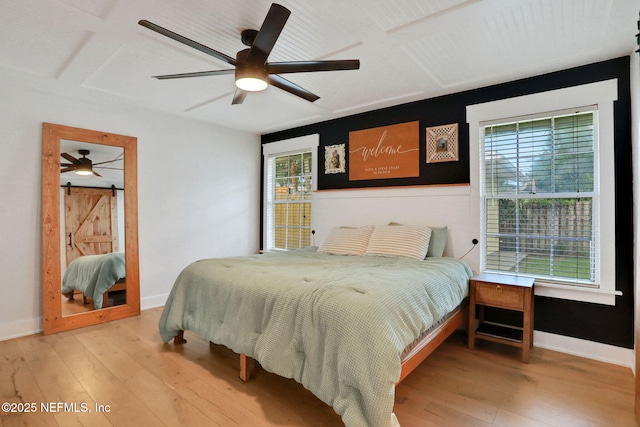 1257 12th St N, Jacksonville Beach, FL 32250 - bedroom with multiple windows, hardwood / wood-style floors, and a barn door