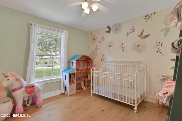 1257 12th St N, Jacksonville Beach, FL 32250 - bedroom featuring multiple windows, baseboards, hardwood / wood-style flooring, a nursery area, and wallpapered walls