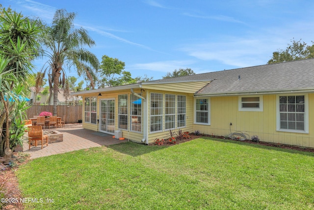 1257 12th St N, Jacksonville Beach, FL 32250 - back of property featuring a patio, a sunroom, and roof with shingles