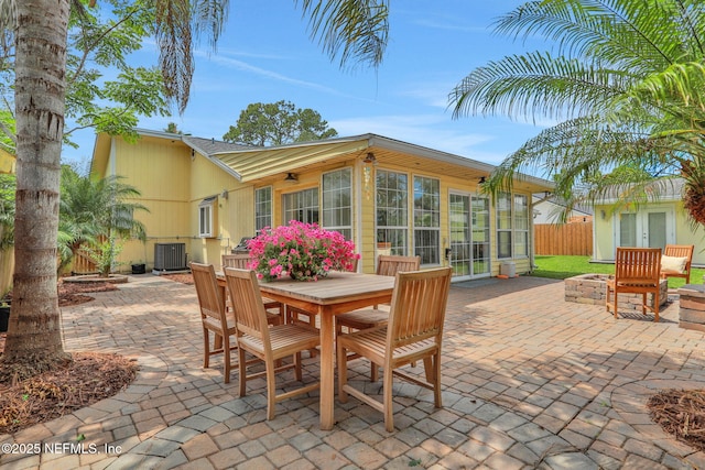 1257 12th St N, Jacksonville Beach, FL 32250 - view of patio with cooling unit, fence, french doors, and outdoor dining area