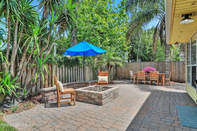 1257 12th St N, Jacksonville Beach, FL 32250 - view of patio with an outdoor fire pit, a fenced backyard, and outdoor dining area