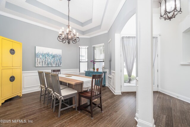 1800 Rear Admiral Ln, Saint Johns, FL 32259 - dining space with a chandelier, a tray ceiling, dark wood-type flooring, ornamental molding, and wainscoting