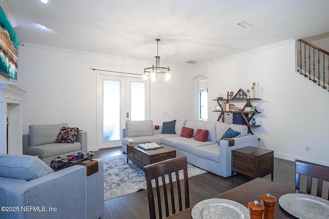 1800 Rear Admiral Ln, Saint Johns, FL 32259 - living room with wood finished floors, crown molding, arched walkways, a chandelier, and baseboards