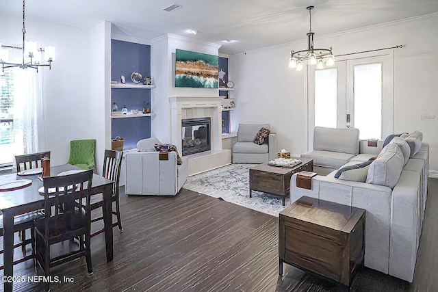1800 Rear Admiral Ln, Saint Johns, FL 32259 - living room with a chandelier, healthy amount of natural light, a tile fireplace, dark wood finished floors, and crown molding