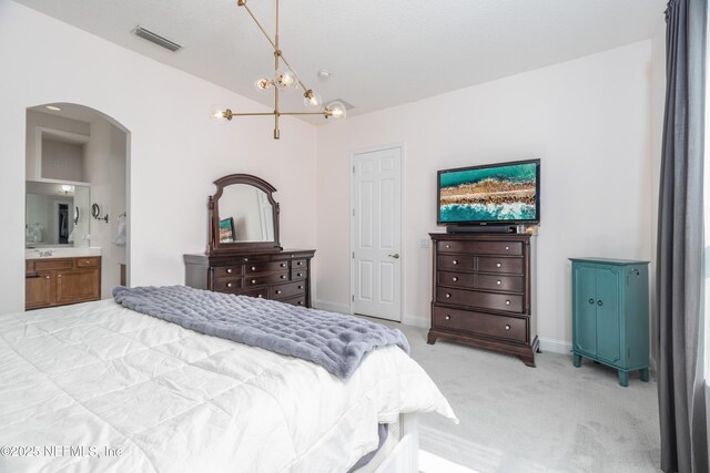 1800 Rear Admiral Ln, Saint Johns, FL 32259 - bedroom with arched walkways, a chandelier, light colored carpet, lofted ceiling, and connected bathroom