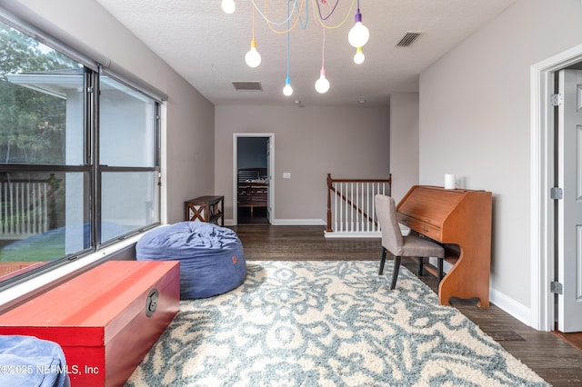 1800 Rear Admiral Ln, Saint Johns, FL 32259 - sitting room with wood finished floors, baseboards, an upstairs landing, and a textured ceiling