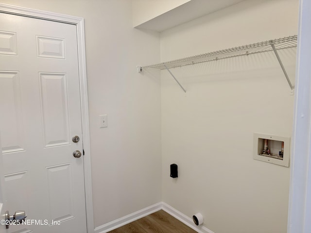 laundry area with baseboards, washer hookup, and dark wood-type flooring