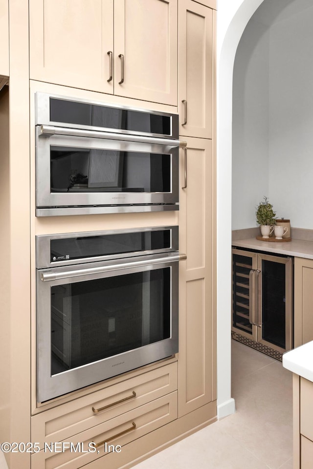 114 12th Ave S Unit 102, Jacksonville Beach, FL 32250 - kitchen featuring oven, wine cooler, arched walkways, and light countertops