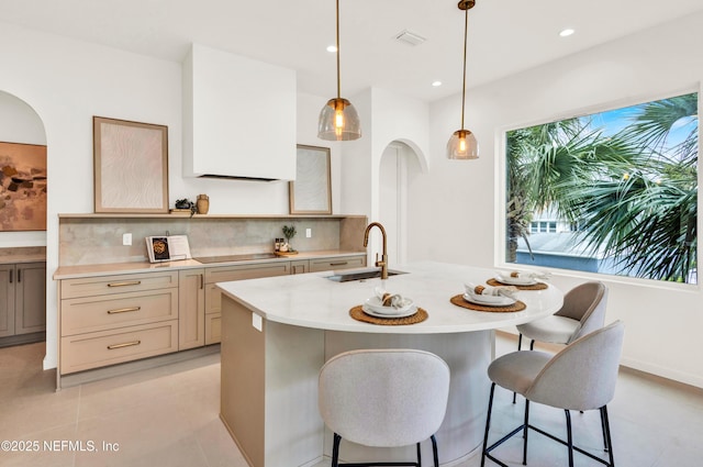 114 12th Ave S Unit 102, Jacksonville Beach, FL 32250 - kitchen featuring light countertops, tasteful backsplash, a kitchen bar, pendant lighting, and recessed lighting