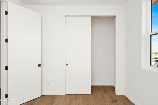 114 12th Ave S Unit 102, Jacksonville Beach, FL 32250 - unfurnished bedroom featuring wood finished floors and a closet