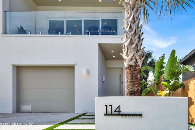 114 12th Ave S Unit 102, Jacksonville Beach, FL 32250 - view of front facade featuring stucco siding and an attached garage