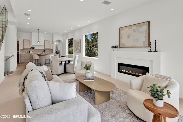 114 12th Ave S Unit 102, Jacksonville Beach, FL 32250 - living area with recessed lighting, arched walkways, and a glass covered fireplace