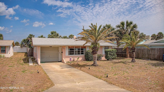 view of front of house featuring concrete driveway and a garage