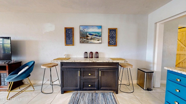 interior space with tile patterned floors and baseboards