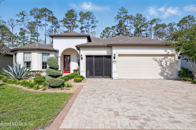 123 Tree Side Ln, Ponte Vedra, FL 32081 - view of front facade featuring an attached garage, decorative driveway, stucco siding, a front yard, and roof with shingles