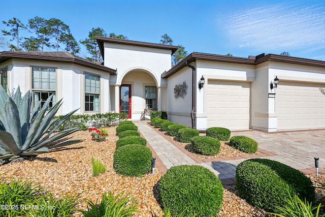 123 Tree Side Ln, Ponte Vedra, FL 32081 - mediterranean / spanish-style home with stucco siding, an attached garage, and decorative driveway