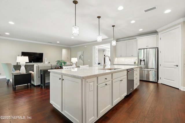 123 Tree Side Ln, Ponte Vedra, FL 32081 - kitchen featuring stainless steel appliances, a sink, white cabinetry, an island with sink, and crown molding