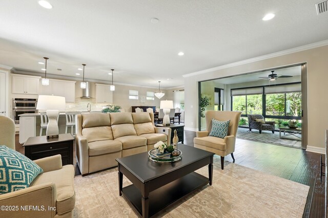 123 Tree Side Ln, Ponte Vedra, FL 32081 - living room with recessed lighting, ornamental molding, ceiling fan, baseboards, and light wood finished floors