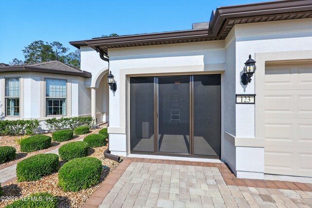 123 Tree Side Ln, Ponte Vedra, FL 32081 - property entrance with stucco siding and a garage
