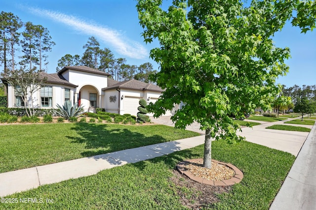 123 Tree Side Ln, Ponte Vedra, FL 32081 - mediterranean / spanish house with stucco siding, a garage, a front yard, a shingled roof, and driveway