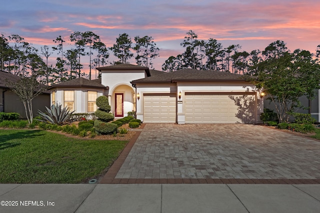 123 Tree Side Ln, Ponte Vedra, FL 32081 - view of front facade featuring an attached garage, decorative driveway, stucco siding, and a yard
