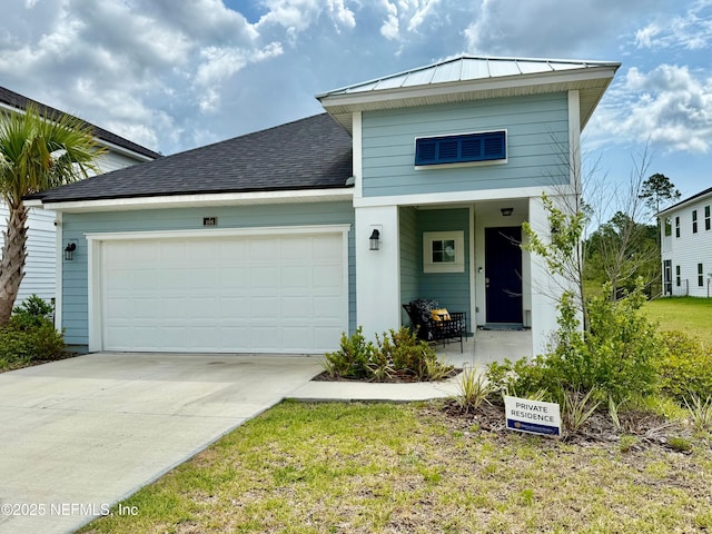 195 Torres Trce, Saint Augustine, FL 32095 - view of front facade featuring a standing seam roof, a garage, concrete driveway, metal roof, and a shingled roof